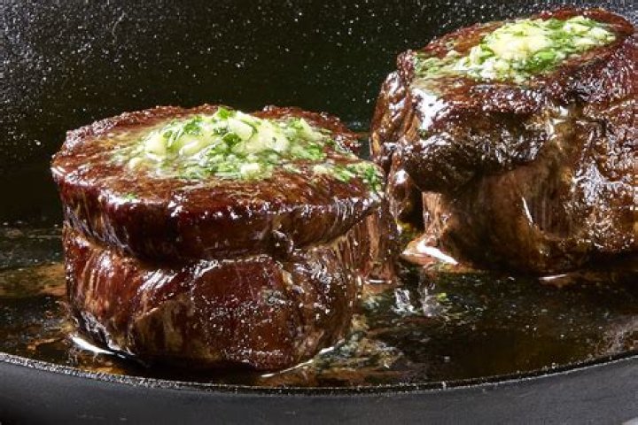 How do most steakhouses cook steak?