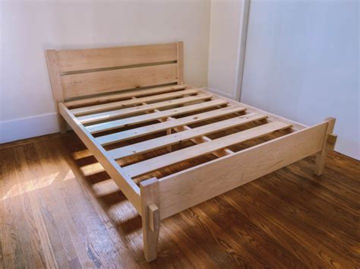 How do you stabilize a wooden bed frame?