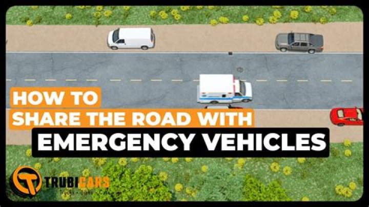 When an emergency vehicle is approaching and you are in the middle of an intersection you should?