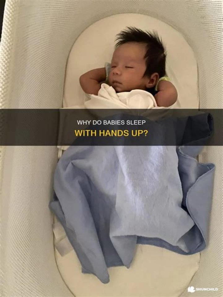 Why do babies sleep with hands up?